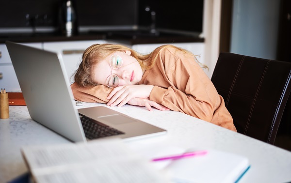 girl resting in front of a laptop