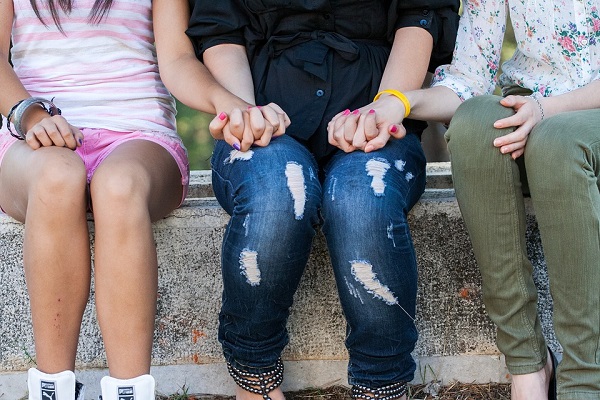 young girls holding hands