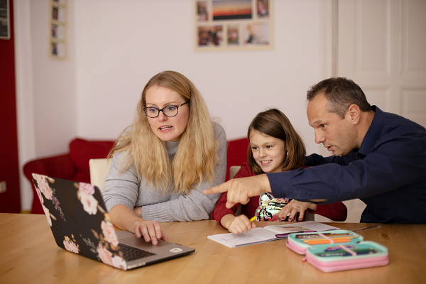 parents helping their child to do home work