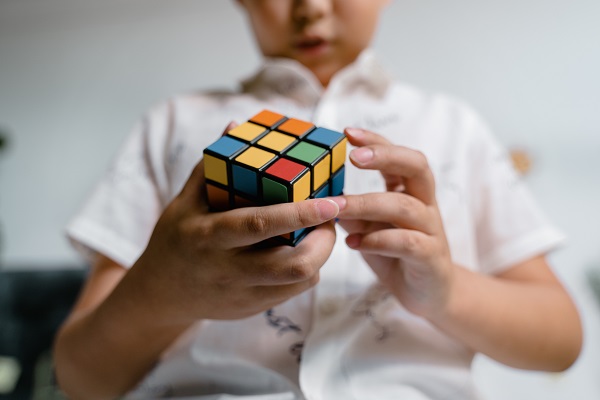Child solving a Rubik's cube
