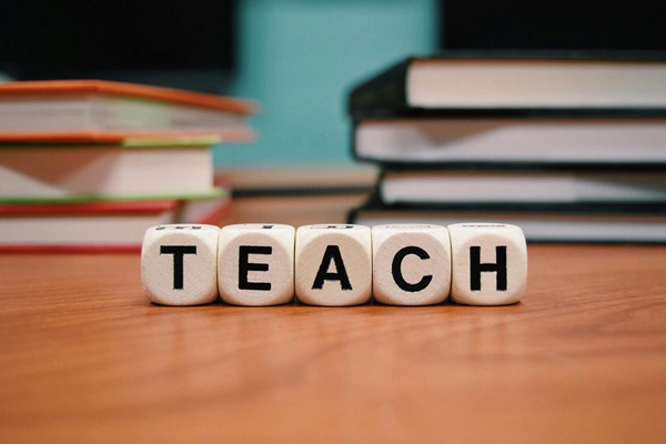 Scrabble blocks that spell TEACH