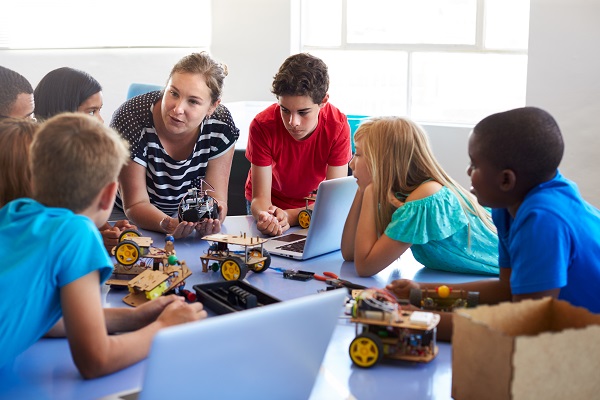 teacher explaining robotics to students