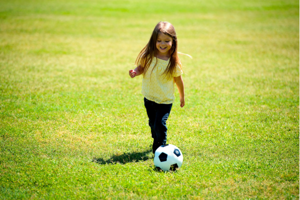 little girl playing football