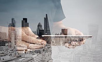 tablet in hands with London in the background