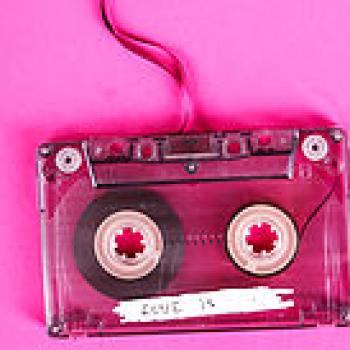 audio cassette tape on a pink background