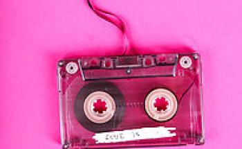 audio cassette tape on a pink background