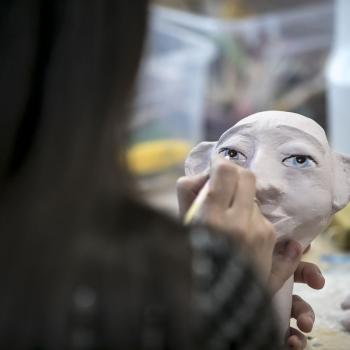 A girl making a puppet