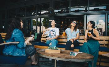 Woman talking to each other, laughing, enjoying their time