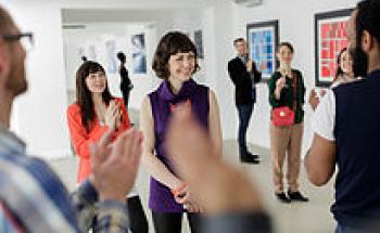 people claping in a white room