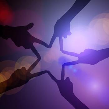 five hands holindg a peace sign and forming a star together