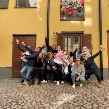 Participants in a course in Stockholm standing together in a group with joyful and funny positions