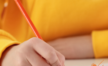 Child writing with a pencil