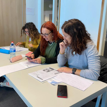 Three students sitting at a desk
