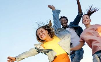 Happy female student feeling empowered (jumping in the air and smiling)