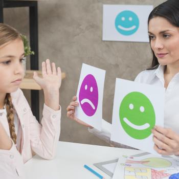 smilling-school-councelor-showing-happy-sad-emotions-faces-cards-girl-child