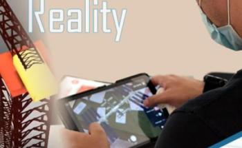 The image shows a teacher testing the augmented reality applications.
