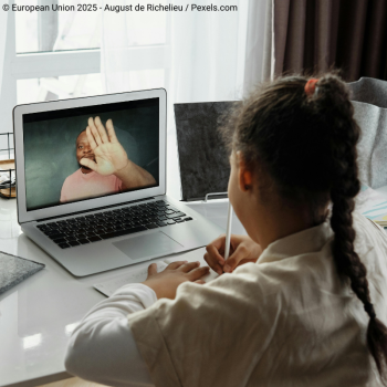 girl looking at teacher onscreen