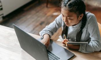 Girl pointing at laptop 