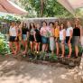 Photo of a group of happy teachers standing next to the vegetable garden they created with us in one of our Pedagogical Vegetable Gardens trainings.