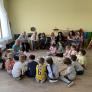 Teachers and children in a circle discussing a logical assignment
