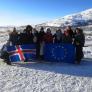 Participants in the Icelandic countryside posing with the EU and Icelandic flags.