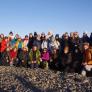 Group photo of participants outside in Iceland with a beautiful blue sky behind.
