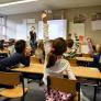 Child raising her hand in class