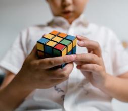 Child solving a Rubik's cube