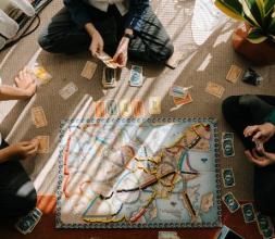 Children playing a board game including a map