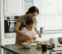 Mother and daughter cooking together 