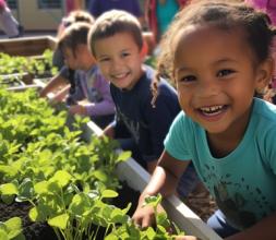 Children smiling and gardening