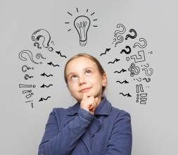 Young girl with illustrations of question marks and a lightbulb