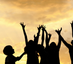 Kids silhouette in a field, playing