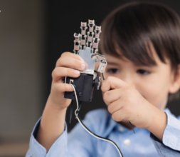 Kid playing with robot hand