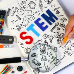 Book containing STEM subjects symbols