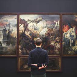 A man in front of a painting