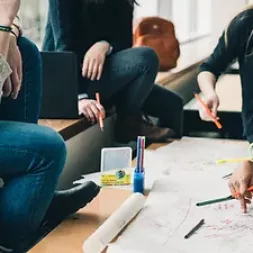 People around a desk doing a group task