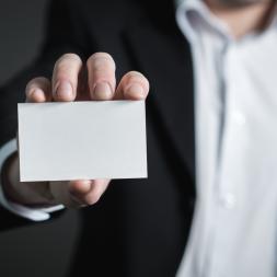 man holding his business card