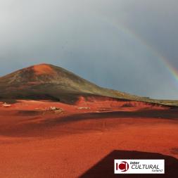 Picture of a volcano under the rain bow and the ICI logo
