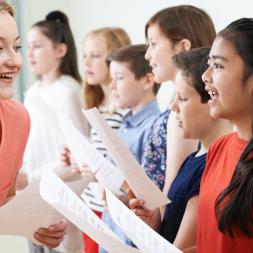 students singing with teacher