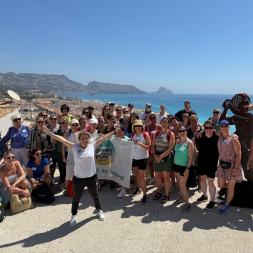 Participants gather for a group photo overlooking the stunning coastline, celebrating play, movement, and well-being in education.