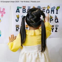 little girl learning letters