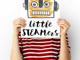 A kid holding a sign that says "Little STEAMERS"