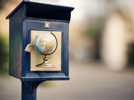 Postbox with a world globe at the front of it