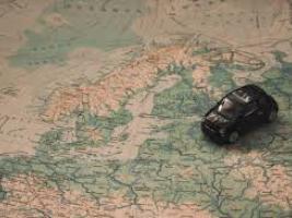 car toy riding above the map of Europe