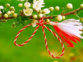 The image represents the symbol of Little March. A white string is knitted with a red string. There are lots of meanings but mostly, the red symbolisez love and courage and the white one the coulour of the first Spring flower (ghiocel), the purity.